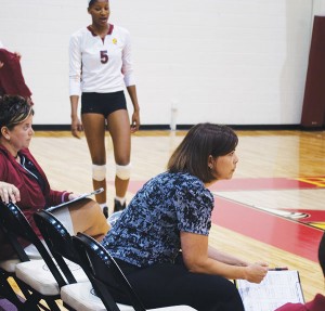 <span class='credit'>Photo By: Kristyn Sonnenberg | Photo Editor</span><span class='description'>Coach Tia Brandel-Wilhelm pays close attention as the Ferris women’s volleyball team fights for victory at a recent match. She began coaching volleyball in 1993 and has since led her teams to 393 victories.</span>