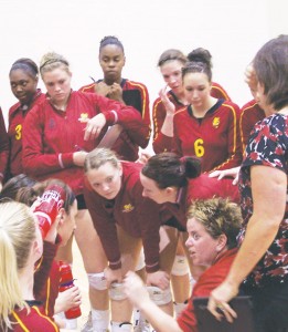 Talk It Out: Head Coach Tia Brandel-Wilhelm (far right) and Assistant Coach Theresa Beeckman (bottom right) advise their team during a time out. The Bulldogs triumphed 3-0 at their most recent game this Saturday against Lake Superior State after Friday’s 3-1 loss to Saginaw Valley State. Photo By: Kristyn Sonnenberg | Photo Editor