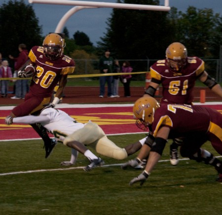 Winning Streak: Tyler Thomas, sophomore, attemps to leap over the Tiffin defense during Saturday’s game. The Ferris State football team took down the Tiffin Dragons on Saturday, Sept. 25. This brings the Bulldog record to 3-1 for the 2010 season. Photo By: Kate Dupon | Photo Editor