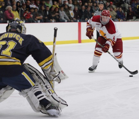 Struggle Against Michigan: Junior defenseman Chad Billins makes a move just before scoring a shootout goal against University of Michigan goalie Shawn Hunwick. The Bulldogs defeated Michigan 3-2 in a shootout on Friday night and lost 3-2 on Saturday. The Bulldogs’ record is 4-3-1 overall this season. Photo By: Brock Copus | Photographer