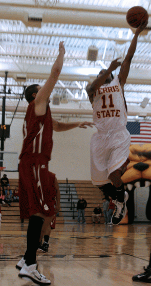 Going Up: Bulldog senior guard Darien Gay shoots a layup over a St. Joseph’s defender in a 66-55 victory over the Pumas on Nov. 15. Photo By: Kate Dupon | Photo Editor