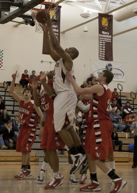 Ferris No. 1: Justin Keenan reaches for a basket during the Feb. 5 game against Saginaw Valley. The Bulldogs have now won 10 consecutive games and are currently ranked No.1 GLIAC North. Photo By: Kate Dupon | Photo Editor