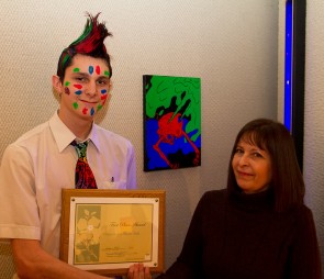 Judge’s Choice: Ethan Wagner, winner of Judge’s Favorite at the Honors Art Show, poses with judge Lynette Vought in front of his winning artwork. Photo By: Brock Copus | Photographer