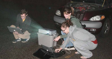 Preparing Projections: Scott Deca, Lynn Overmyer and Tricia Principe work with their projection files in preparation for Thursday night’s event. Photo By: Kate Dupon | Photo Editor