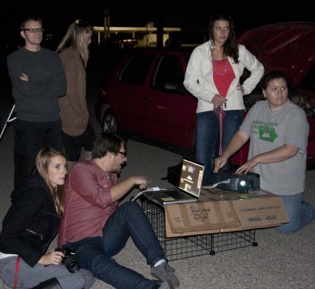 Projecting Ford: Senior graphic design students Ashley Sudney, Sarah Todd, Craig Cockerill, Katie Bell and Toni Neuman test their projects while designer professor William Culpepper observes. Photo By: Kate Dupon | Photo Editor