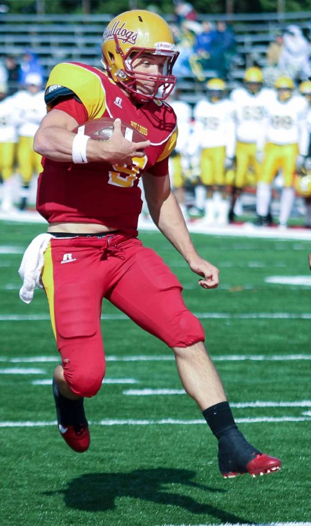 Homecoming Win: FSU senior quarterback Tom Schneider leaps into the end zone for a touchdown against Northern Michigan. Photo By: Brock Copus | Multimedia Editor
