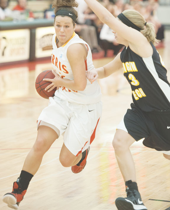 Concentrating Without Consternation: Redshirt freshman Katie Mavis drives toward the basket in a home game against Michigan Tech Jan. 10. Photo Courtesy of Photographic Services