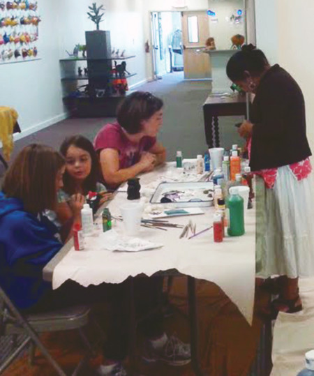 A Lesson in Art: Maria Angeles gives attendees lessons on how to paint in the Oaxacan style during a workshop at the Artworks art gallery. Courtesy Photo By: Ben Rettinhouse
