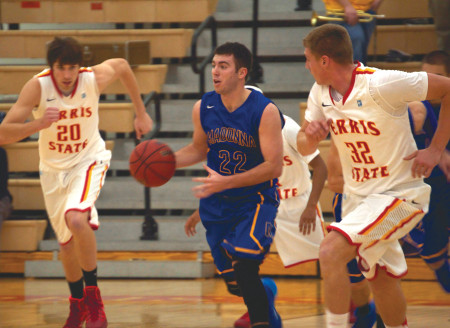 Jared Stolicker (20) rushes back to defense to stop Madonna from scoring, the Bulldogs beat Madonna 97-92. Photo By: Melanie Ronquillo | Photographer