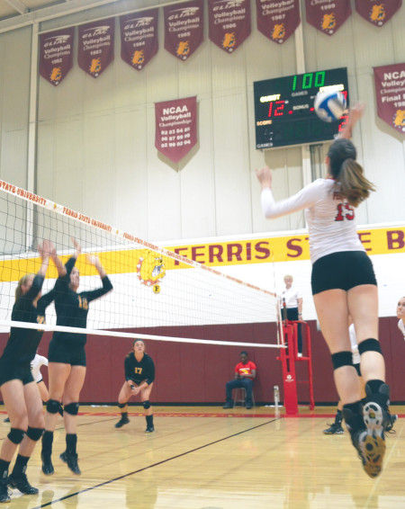 Ferris junior outside hitter Courtney Rehm (15) jumps to spike the ball against Ohio Dominican defenders. Ferris defeated Ohio Dominican this past weekend as they continue their winning streak in the GLIAC. Photo By: Olivia Odette | Photographer