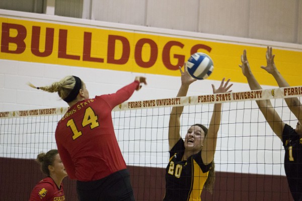 Senior middle hitter Caroline Heitzman elevates above the competition with an aggressive spike against Missouri Western St.