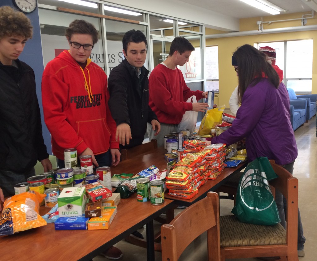 The yellow tribe unloads some of the non-perishable food items that they collected to go to the Manna Pantry downtown.