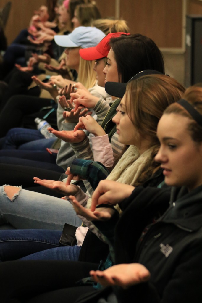 Students at Peter Bielagus’ presentation do an ice-breaking exercise in which they try to grab the finger of their neighbor when Bielagus counted down from three.