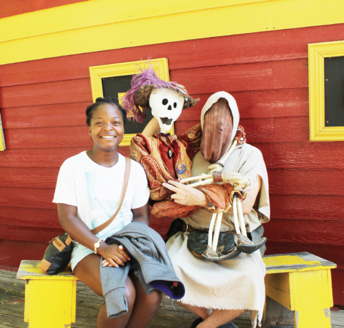 Ferris political science freshman Patience Gwion poses with a masked ventriloquist who hosts the “Ded Bob Sho” at the Michigan Renaissance Festival in Holley.