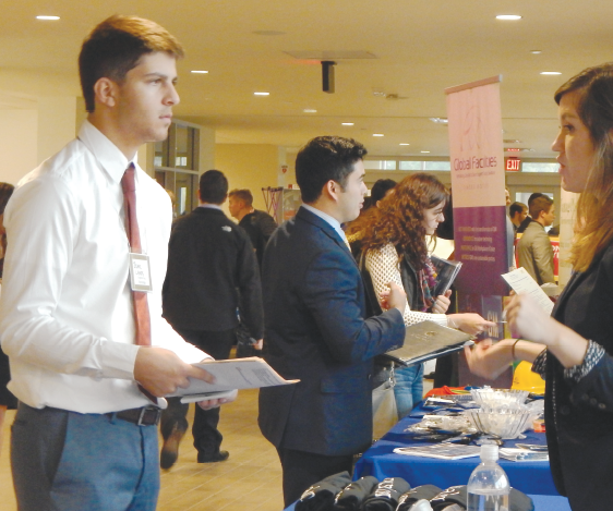 Ferris plastics engineering sophomore Isaac Lampe talks to a representative from North American Lighting in the University Center at Ferris’ 2016 fall career and internship fair.