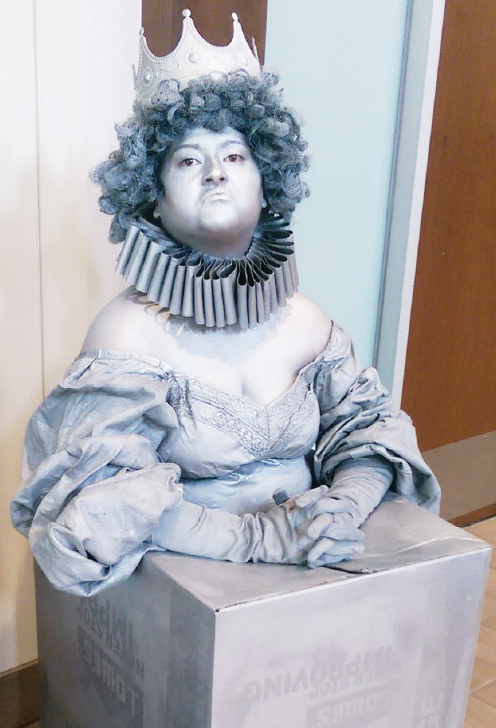 A human statue perched outside of the Quad cafeteria in the UC promoting this weekend’s “Big Fish.”